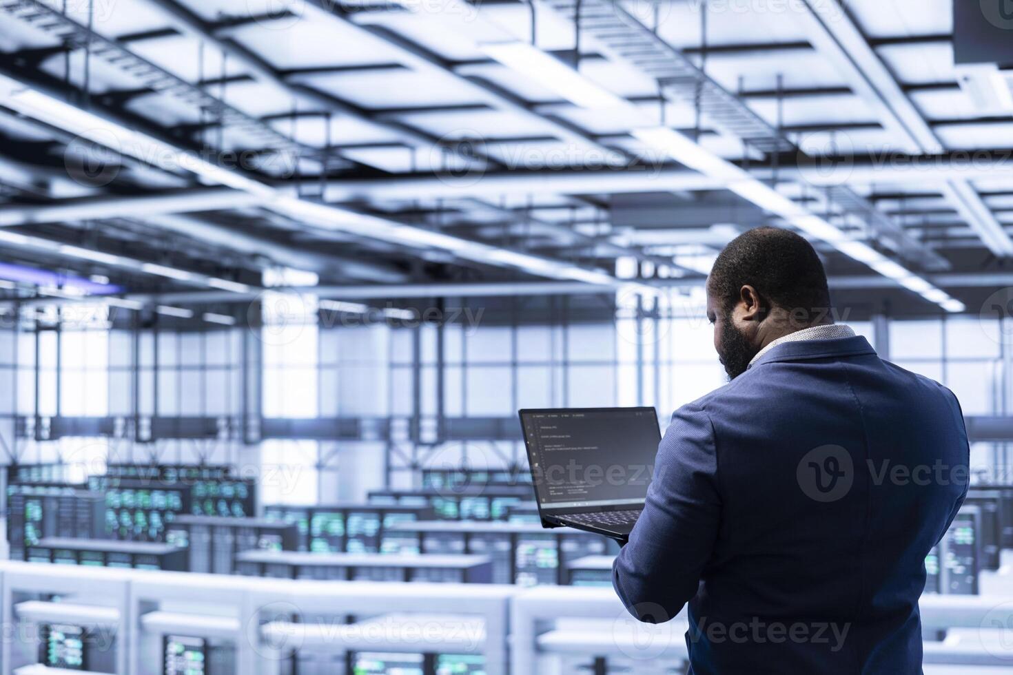 Admin in data center identifying and solving technical malfunctions related to data center systems. IT employee managing, maintaining and securing server hub and mainframe rigs inside photo