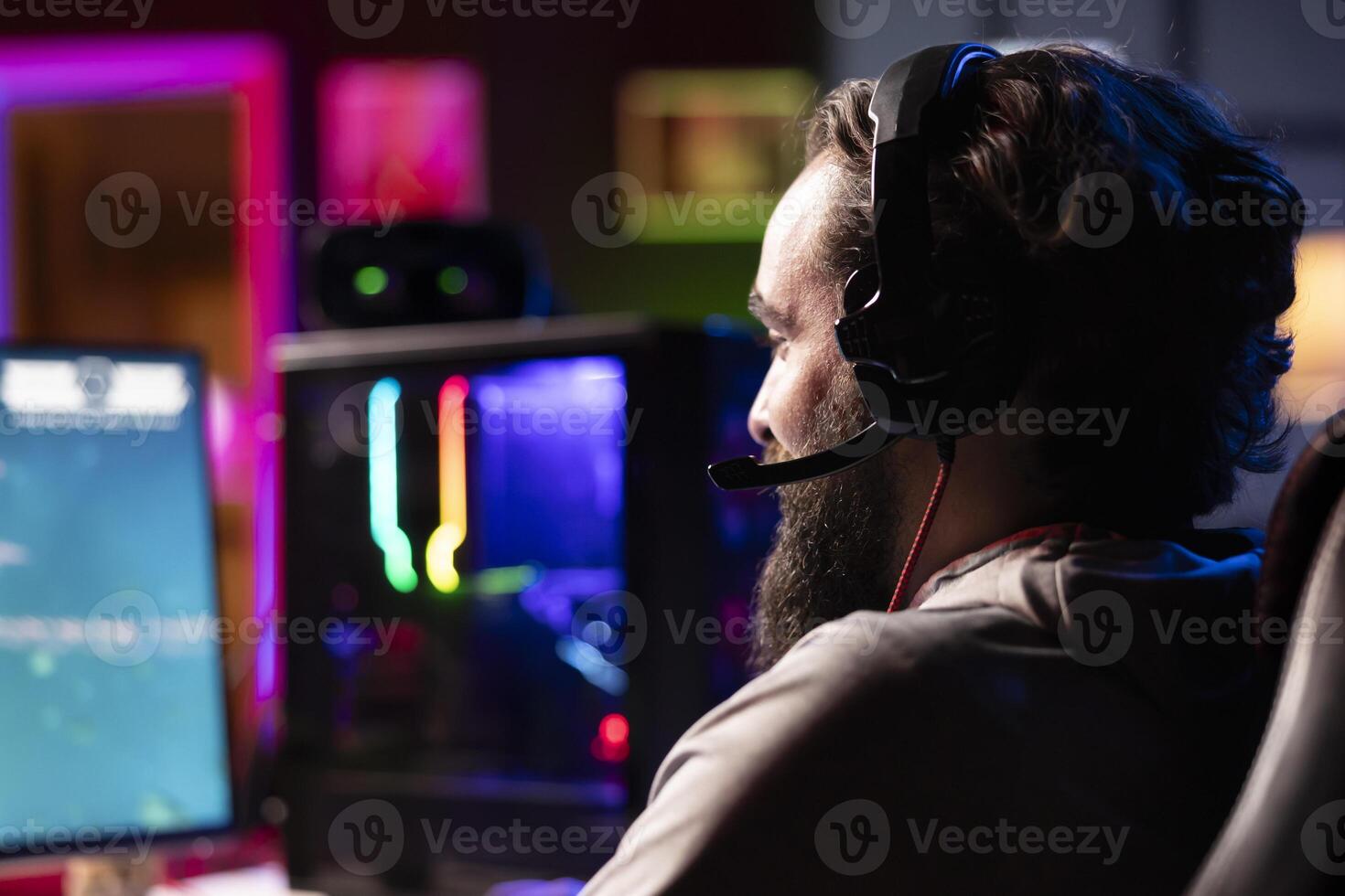 Man discussing with friends online, shooting asteroids together in spaceship flying game. Close up of gamer chatting with teammates while navigating universe in coop game photo