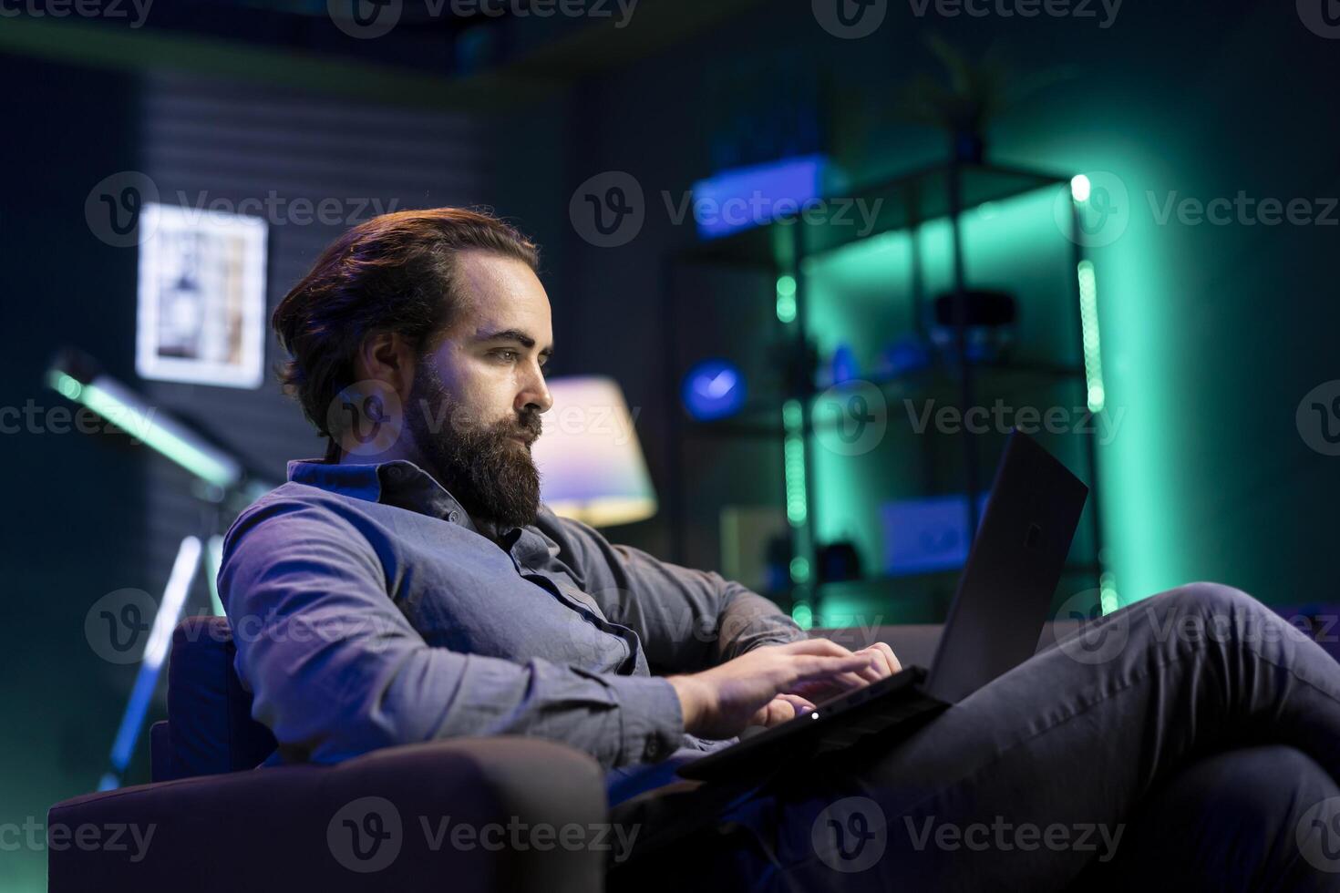 Teleworker writing emails on laptop at home, sending them to business partners. Remote employee working from home in cozy apartment personal office, typing on notebook keyboard photo