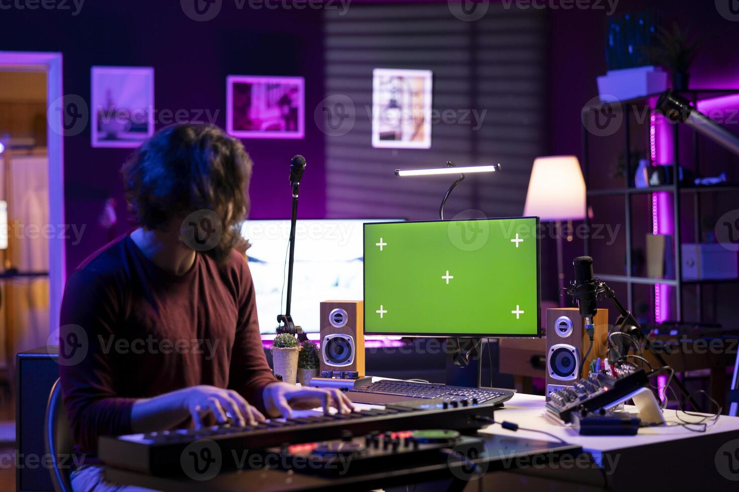Sound engineer hitting electronic piano notes and following tutorials on pc with greenscreen, recording a melody on midi controller keyboard. Beginner musician using synthesizer keys. photo