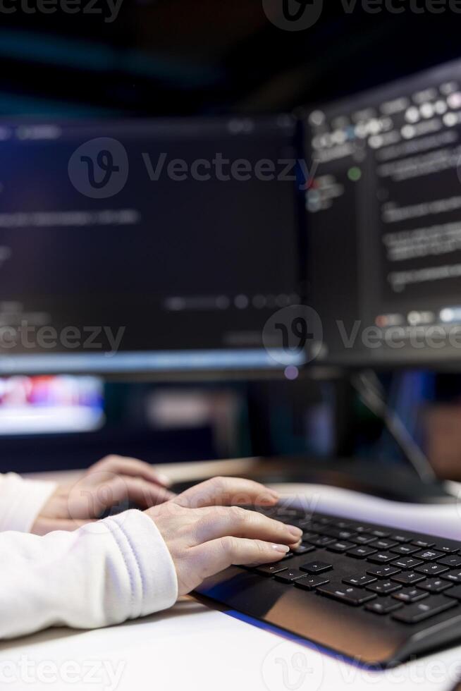 Woman typing on keyboard, implementing security measures to protect company systems and data. Close up shot of IT specialist writing, testing and debugging Java code for software applications, photo