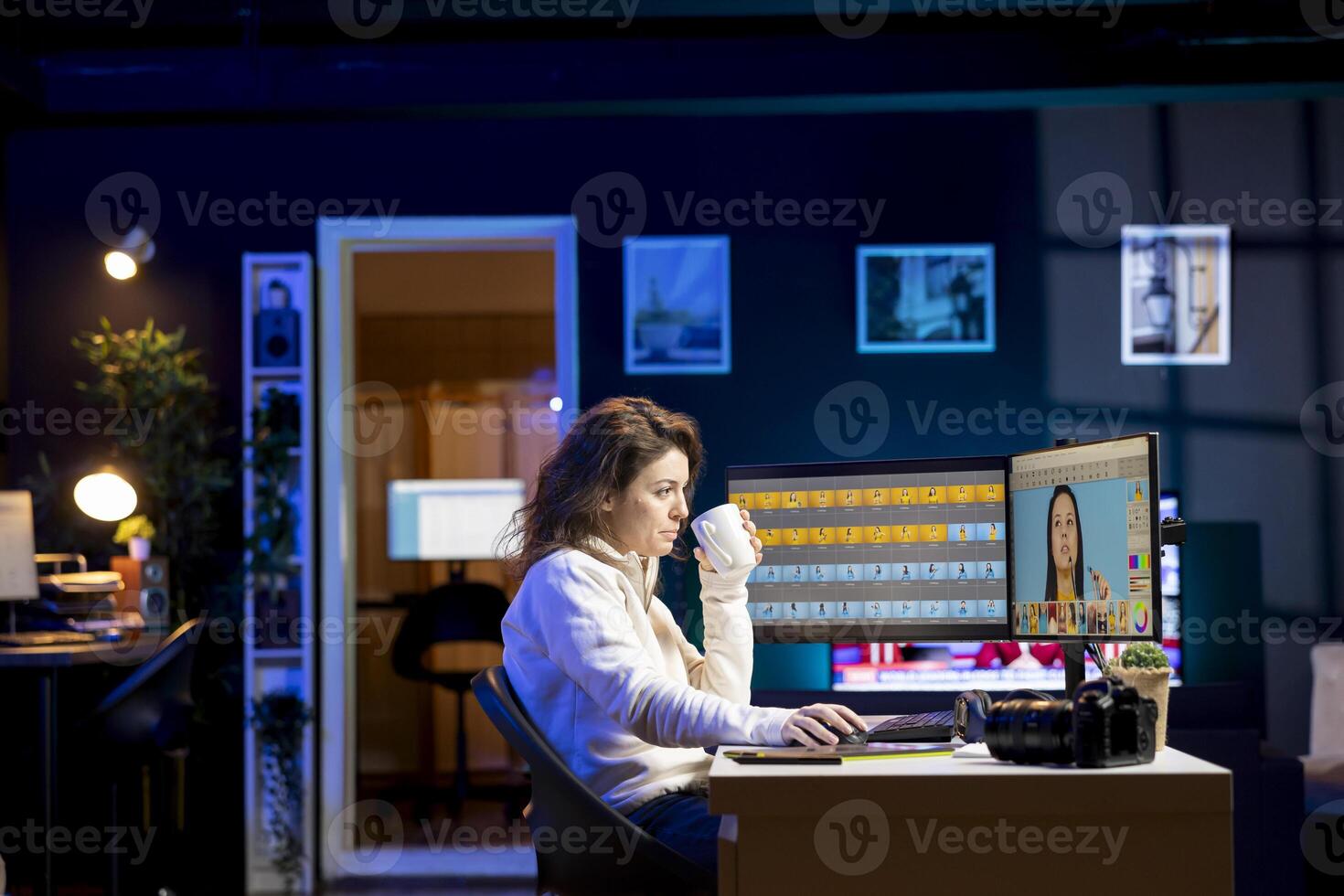 Photographer feeling tired from using photo editing software on PC display, drinking cup of coffee. Freelancer enjoying hot beverage while using photographs retouching program