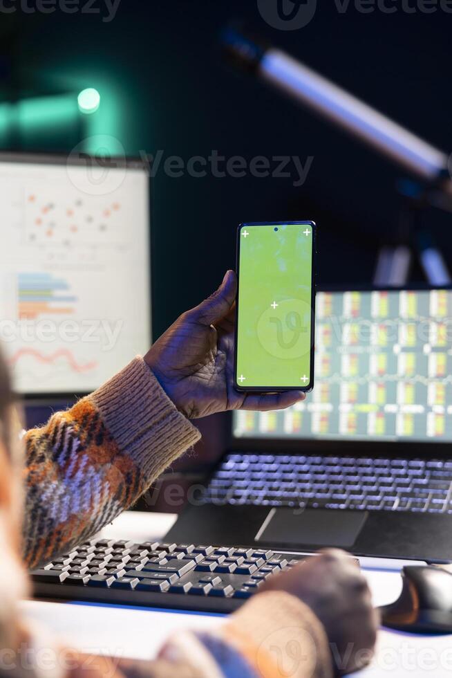 Financial analyst checking isolated chroma key and online balance to calculate cost and revenue elements, doing accounting work at home. Economist looking into capital funds analysis for review. photo