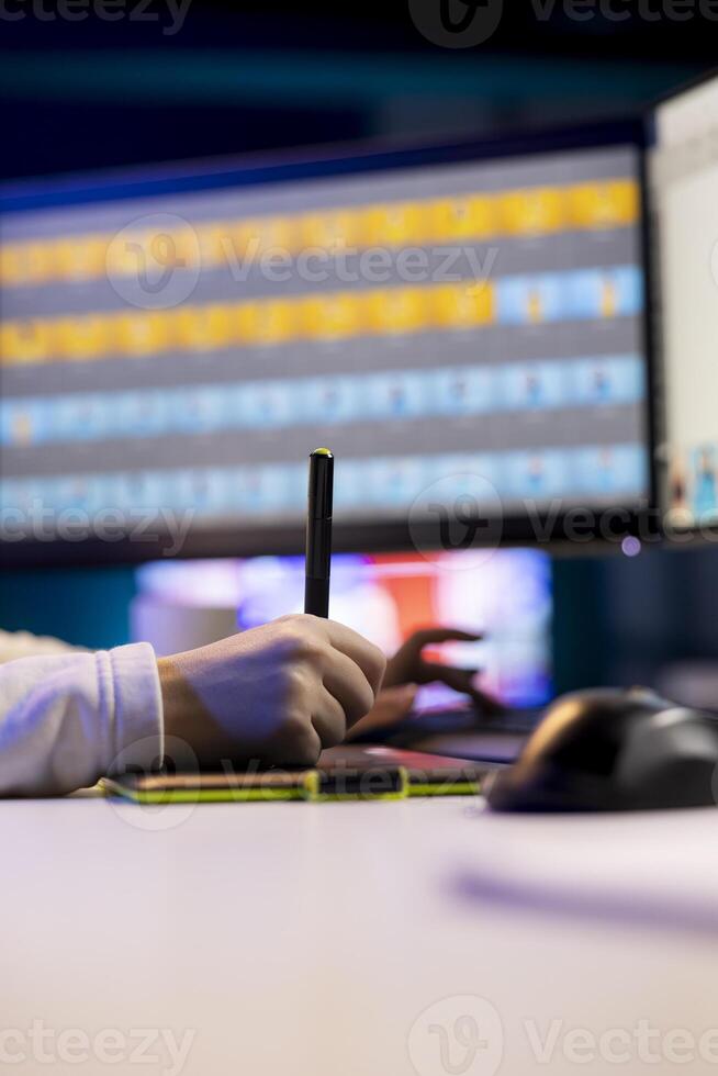 Photo editor working in independent production company using professional graphic tablet. Photographer adjusting white balance on overexposed pictures on touchscreen device using stylus, close up