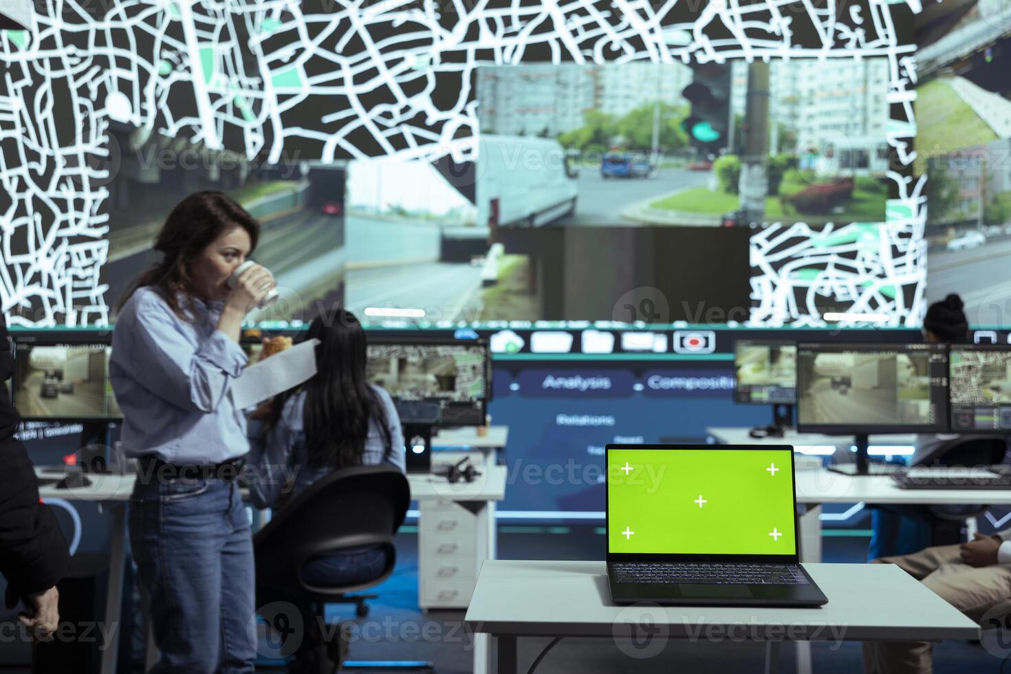 Shipping agency workers examine satellite map next to an isolated screen on laptop, monitoring parcels and orders for customers. Employees using surveillance CCTV system to get updates. photo