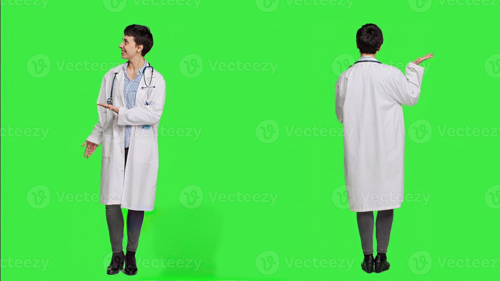 Physician pointing to the left or right to create web commercial standing against greenscreen backdrop, doing a marketing advertisement in studio. Woman medic in white coat shows an ad. Camera A. photo