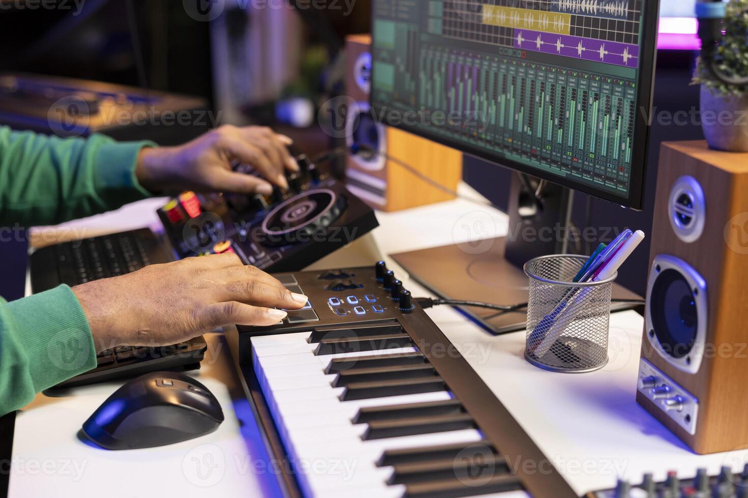 Music producer twisting pre amp knobs on mixing console, editing his audio recordings in home studio. Skilled composer producing new soundtracks with modern equipment. Close up. photo