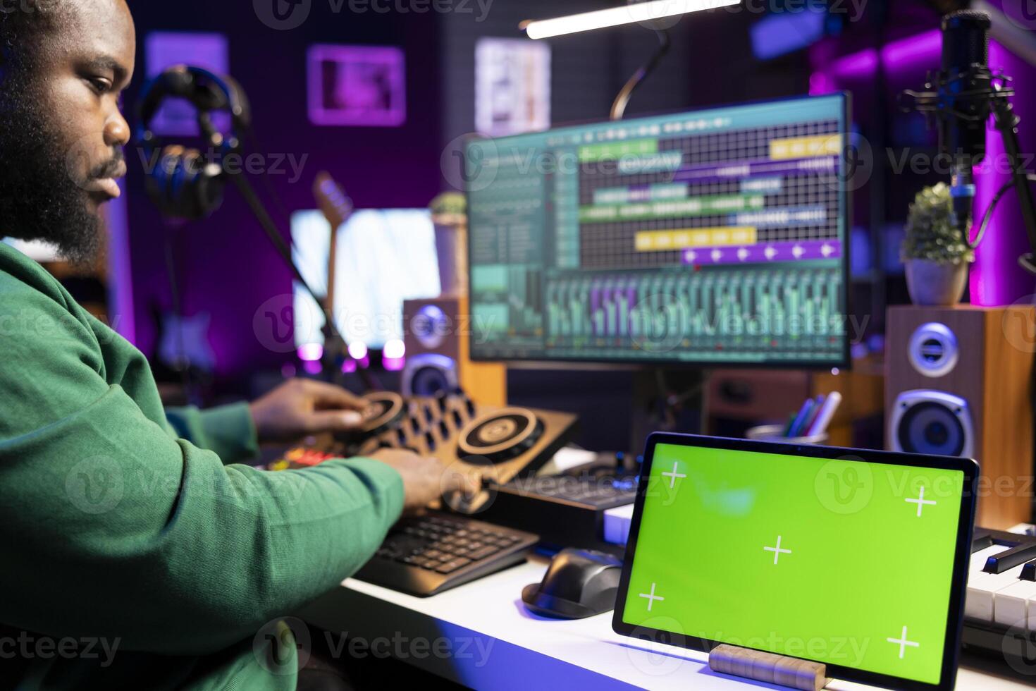 Producer composer mixing and mastering his songs with stereo tools, copyspace screen on a tablet. Audio technician improving sound quality on tracks recorded in post production. photo