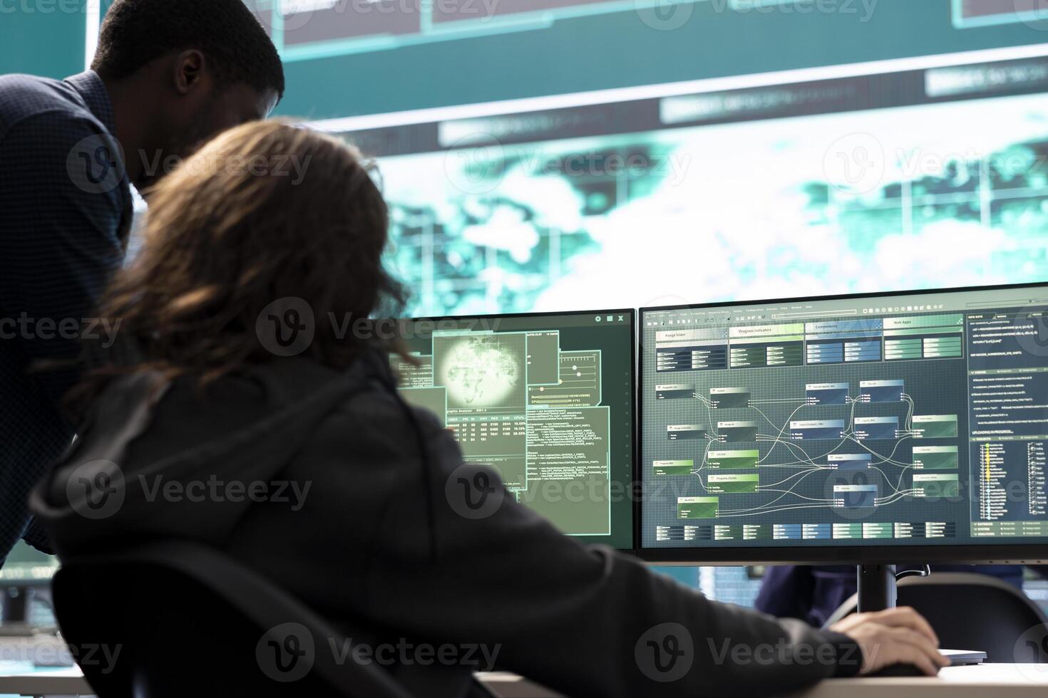 Professional IT expert working in a governmental security operations center, analyzing data on a big screen. Highlighting the importance of cyber security monitoring and threat analysis. photo