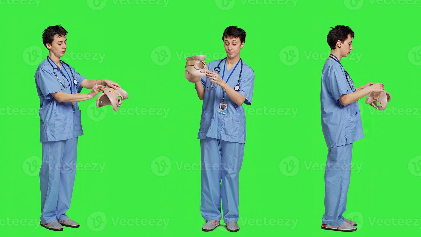 Specialist presenting cervical neck collar used for physical therapy and trauma after an accident or fracture, greenscreen backdrop. Nurse shows orthopedics brace to help with spine injury. Camera A. photo