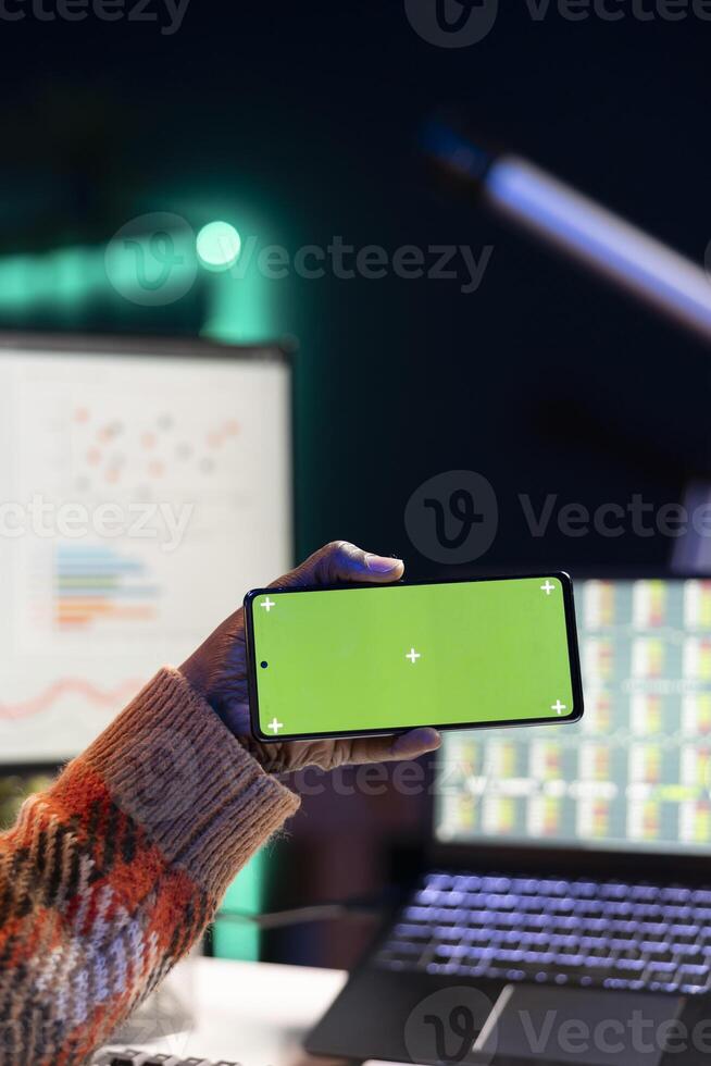 Expert analyst providing online evaluations of finances next to chroma key, solving accounting tasks for authorized balance analysis. At home, economist consultant estimates global earnings. photo