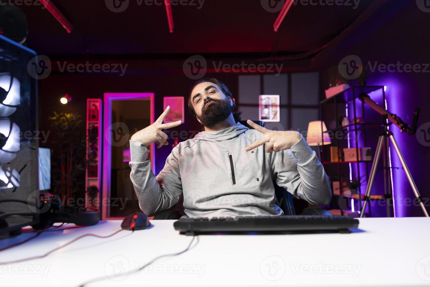 Smug gamer feeling satisfied after winning game, killing enemies and finishing level, throwing peace signs. Happy person bragging after being victorious in videogame, doing hand gesture, feeling proud photo