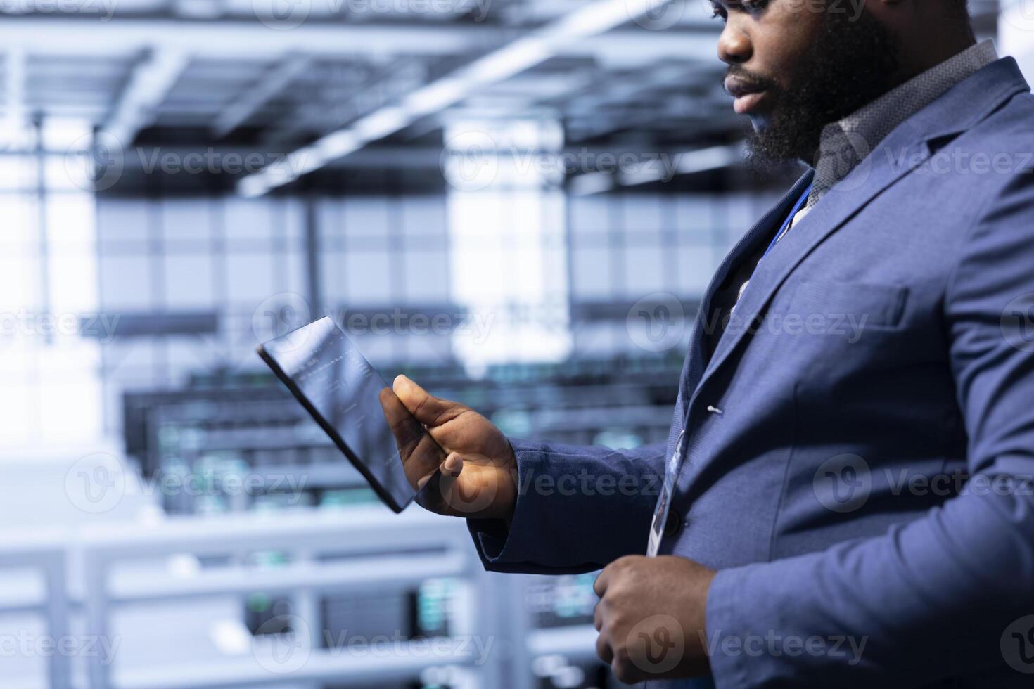 Employee with expertise in disaster recovery planning and security protocol enforcement working in data center. Worker in server room reducing downtime, ensuring business continuity photo