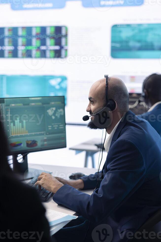 Company associate examining infographics in a organizational headquarters, telecommunications operator analyzing annual reports and statistics. Resources allocation activity in office. photo