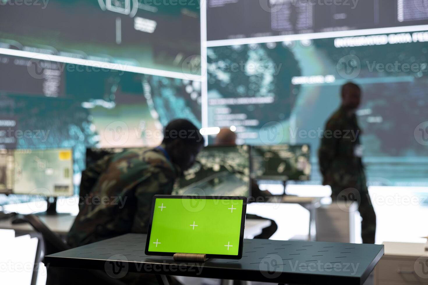 Military headquarters monitoring room with a mockup green screen on tablet, safeguarding the national territory from hostile warships. Skilled trooper serving the country in command center. photo