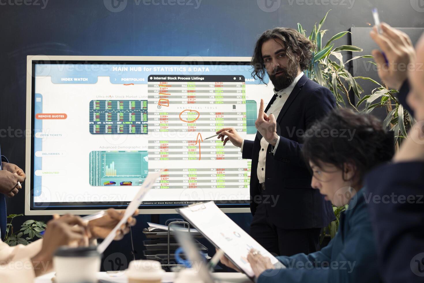 Financial expert briefing his team members about new corporate objectives, presenting their budget and profit on an interactive board. Resource allocation and project planning meeting. photo