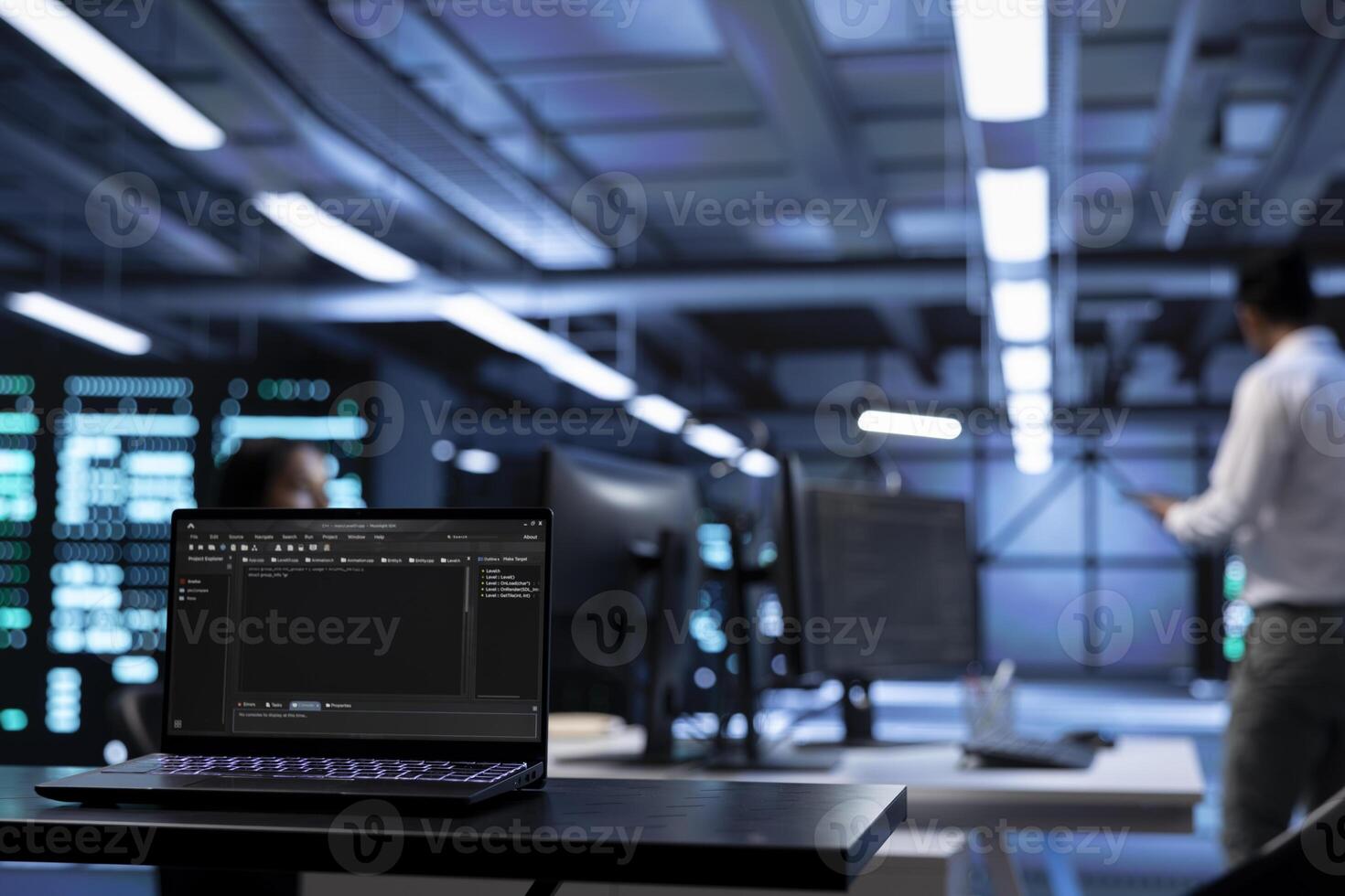 Focus on notebook used by technician in server farm in blurry background to find network issues affecting supercomputer performance. Close up shot of device in data center photo