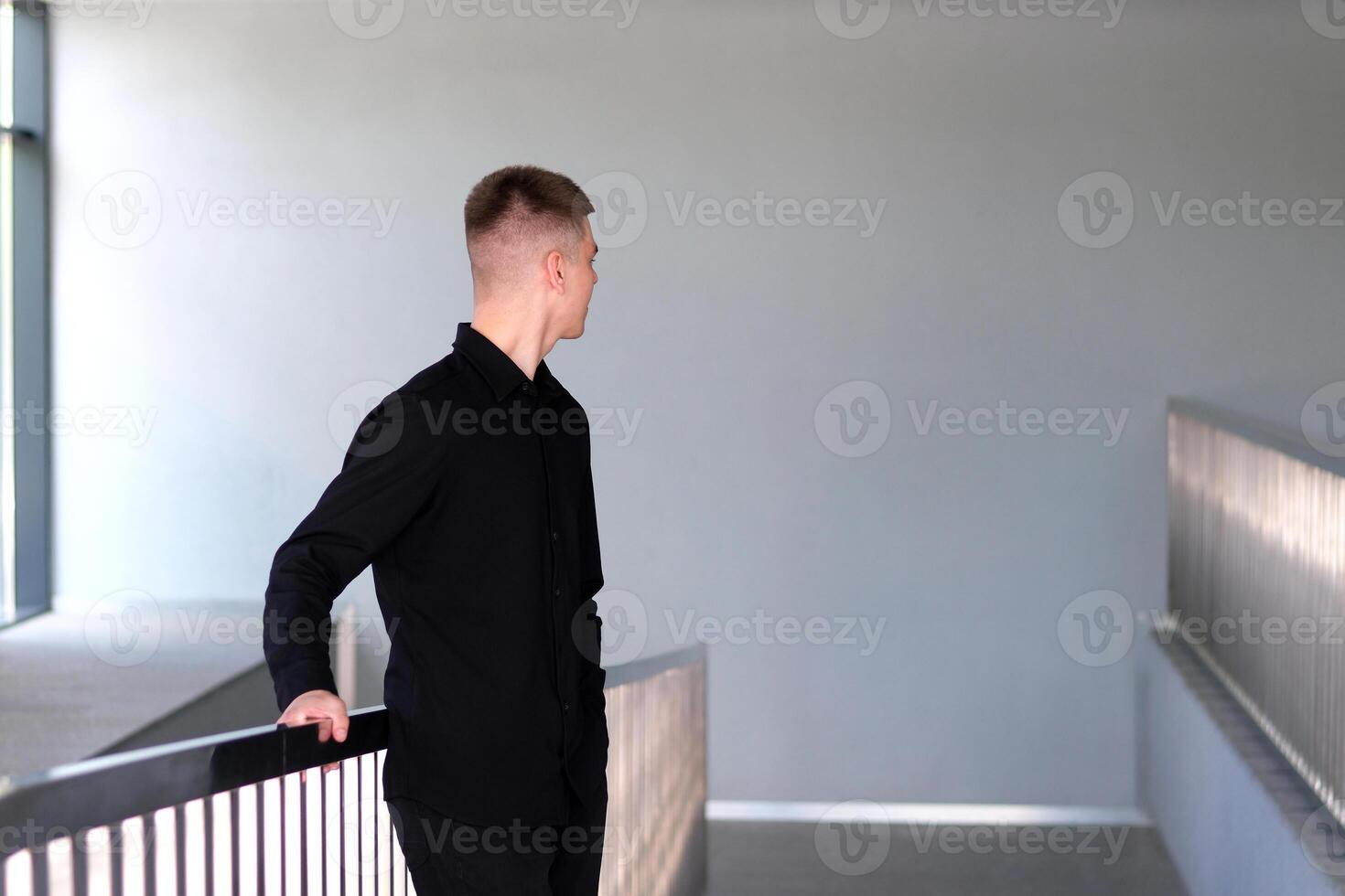 Smiling caucasian businesman in formal outfit looking at camera standing in office. Portrait of happy handsome man wearing suit in open space. Confident corporate worker posing. photo
