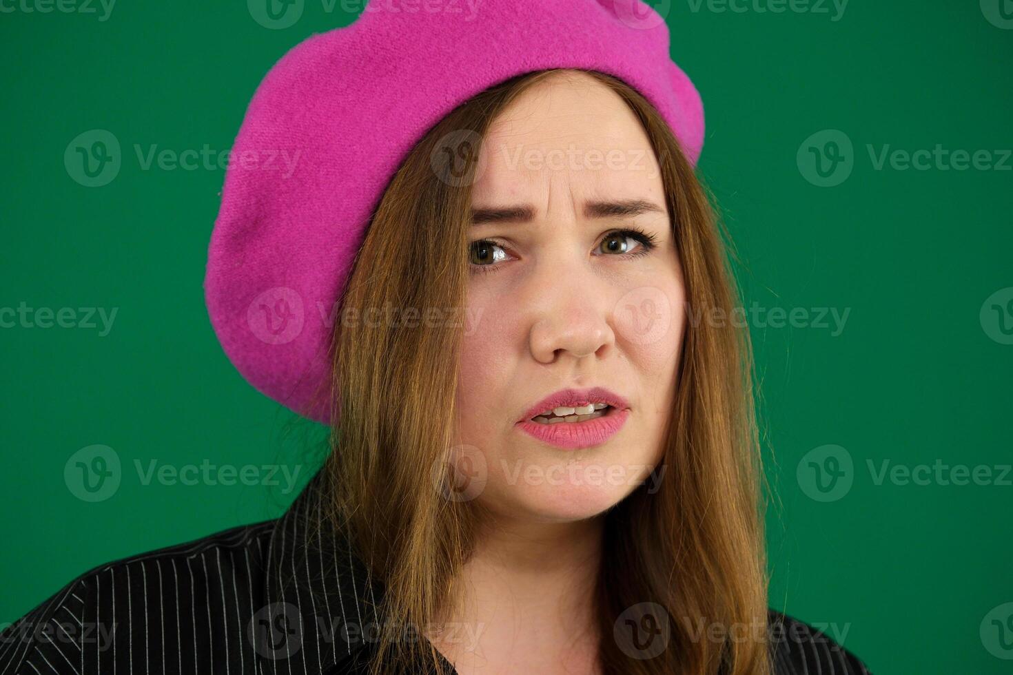 Beautiful woman wears old fashionable clothes, keeps palms pressed together in front of her, pouts lips, has regretful or sorrorful expression, asks friends to stay, not to feel bored, needs attention photo