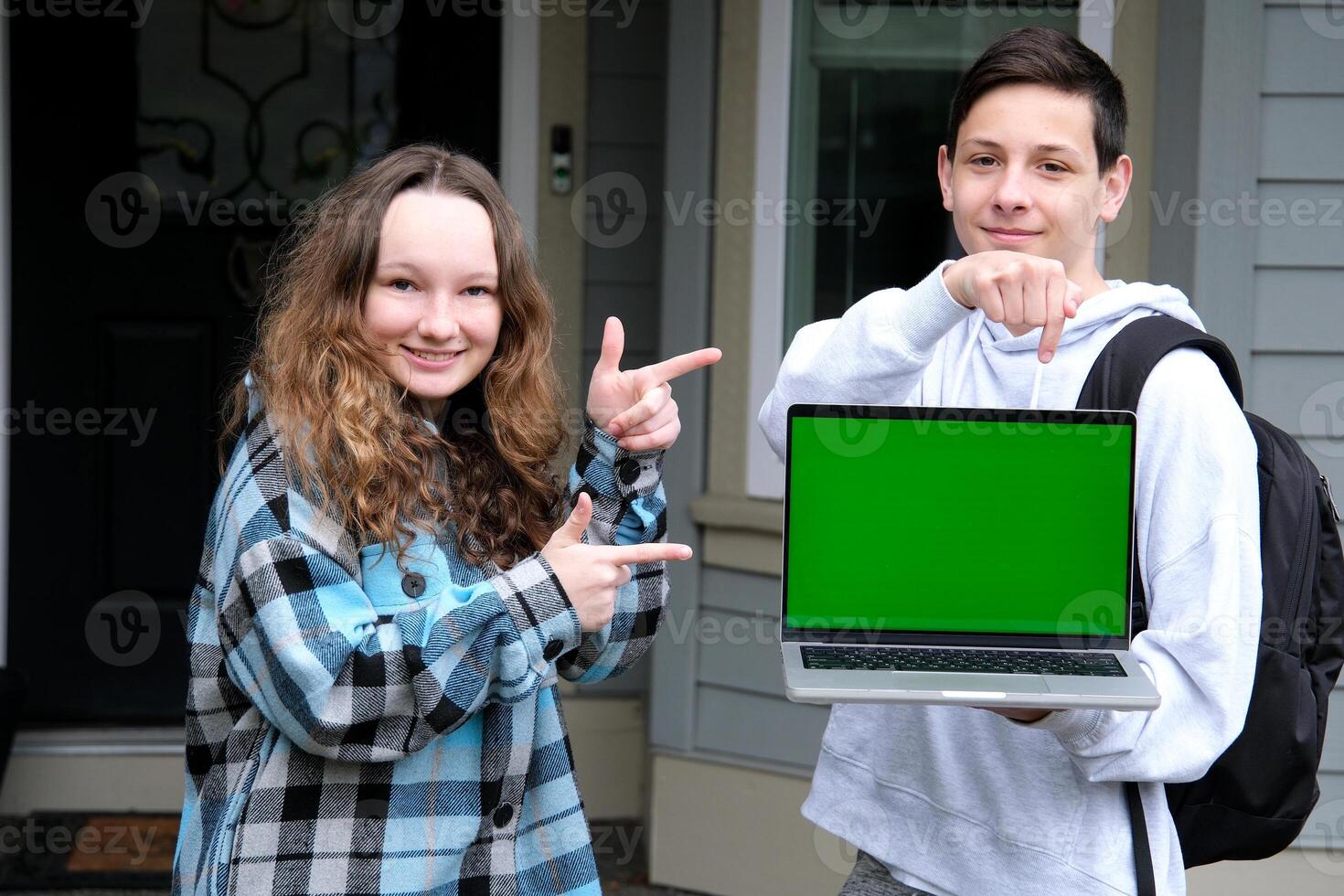 Cropped image of a female college student using her laptop computer and doing a school project with her friends at park. laptop white screen mockup photo