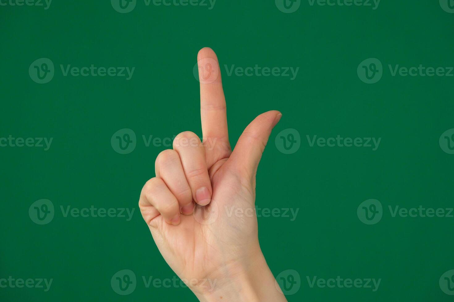pointing at something with your index finger. isolated green background photo