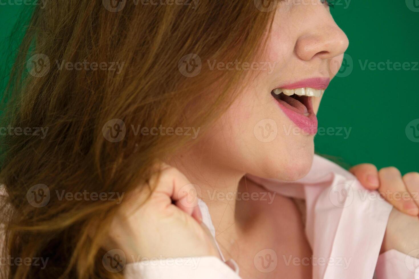 A Caucasian woman found something amusing and having a good laugh at home expression of emotions with hands unrecognizable people hands palms fingers close-up on a green background chromakey feelings photo