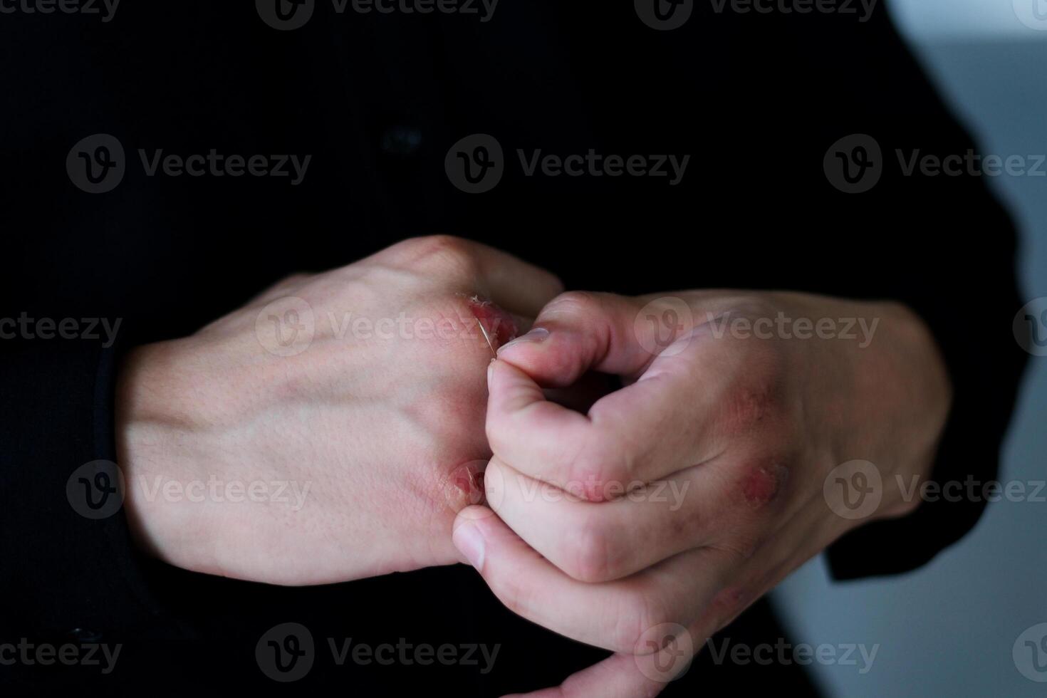 tablet man guy looking at his fingers after boxing holding a tablet in a black shirt standing in the hall photo