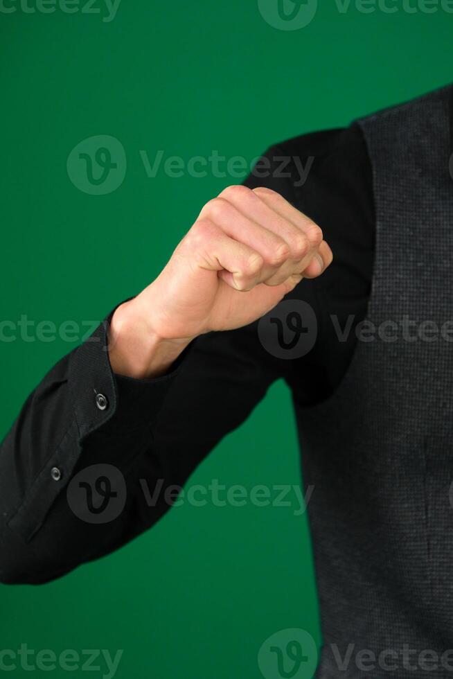 Hand with clenched a fist, isolated on a white background photo