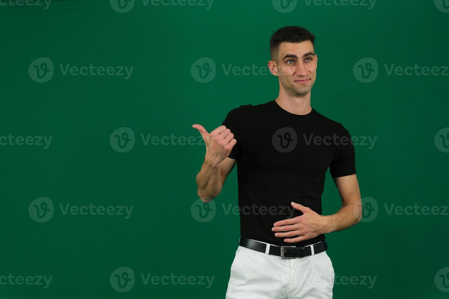 Portrait of attractive glad cheerful man manager demonstrating ad copy space isolated over grey color background photo