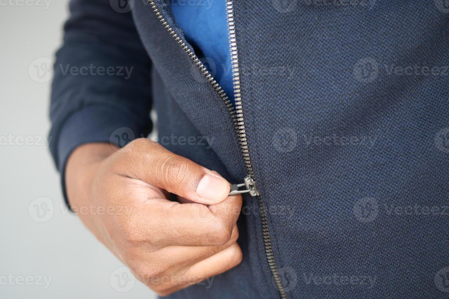 Man zipper on a jacket in cold autumn day. photo