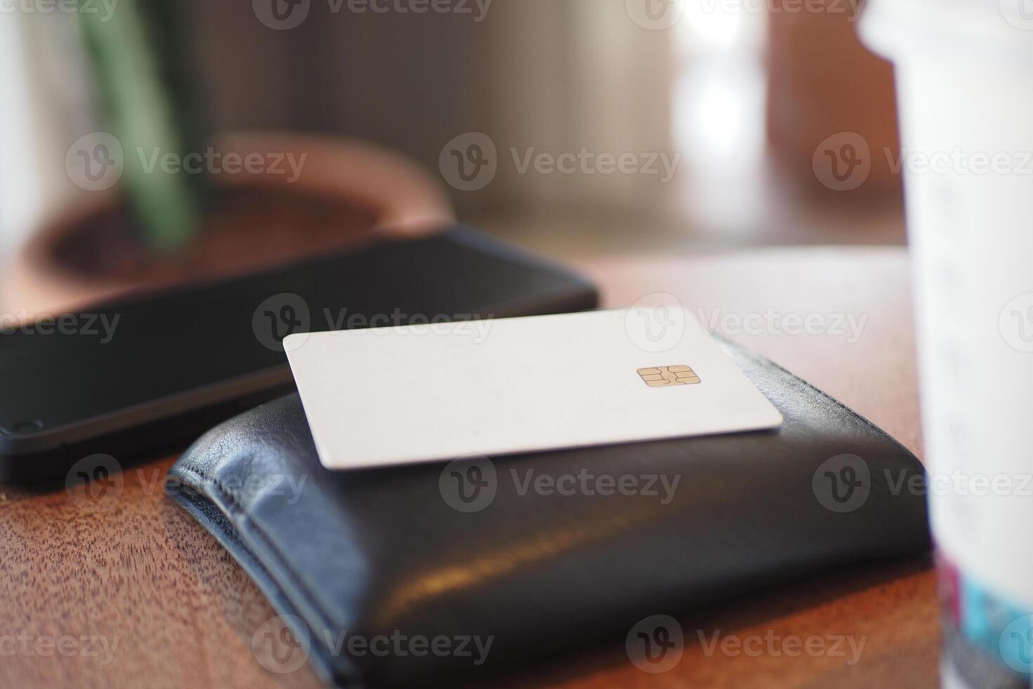 A minimalistic wallet and a card placed neatly on a table surface photo