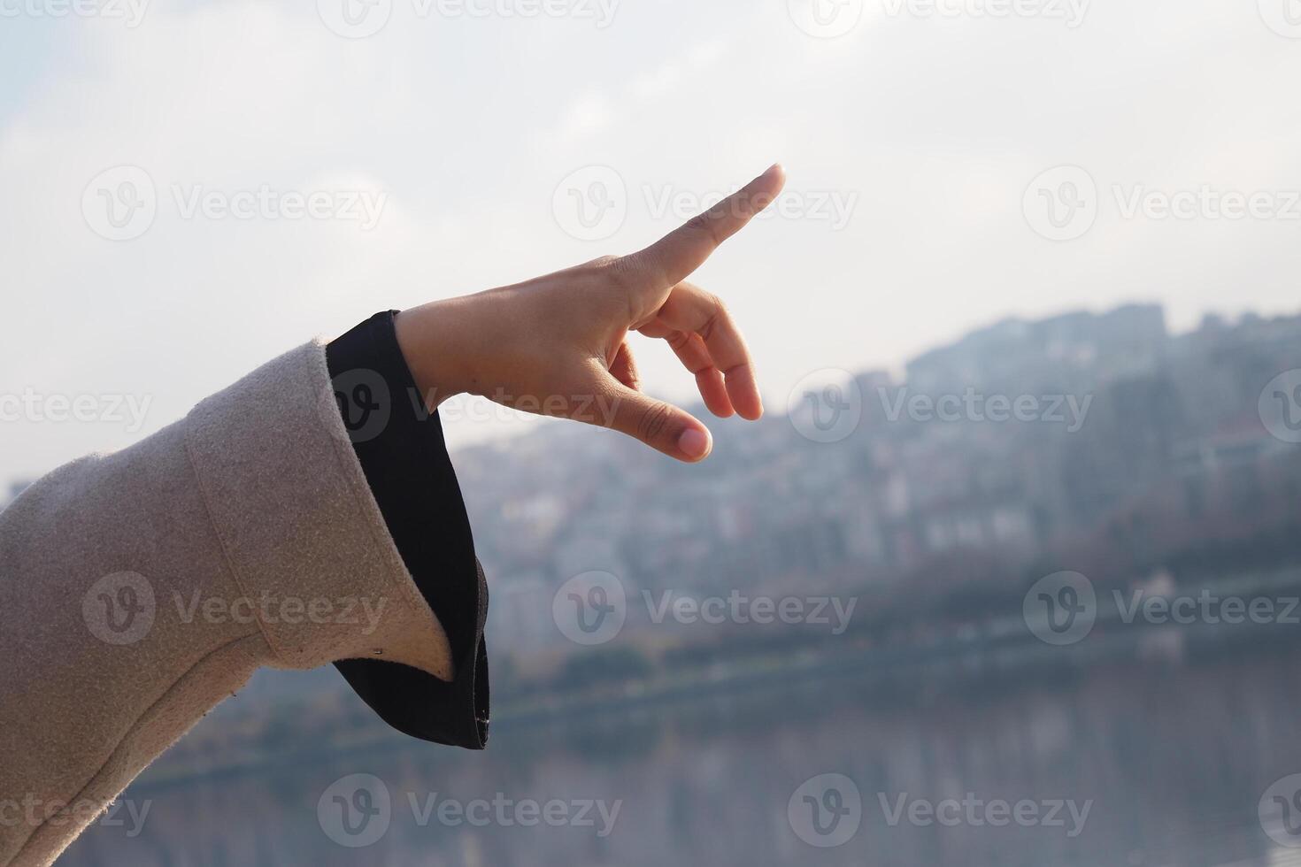 An Elegant Gesture Captured Against a Scenic Urban City Backdrop photo