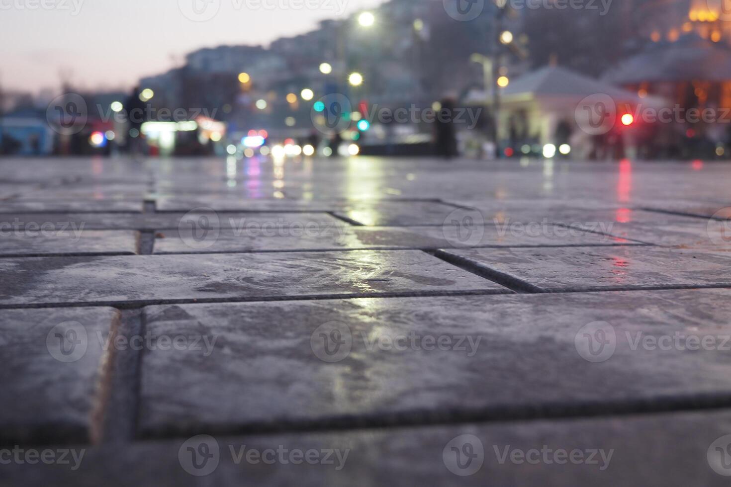 Wet Pavement at Dusk Capturing the Beautiful City Lights Reflection photo