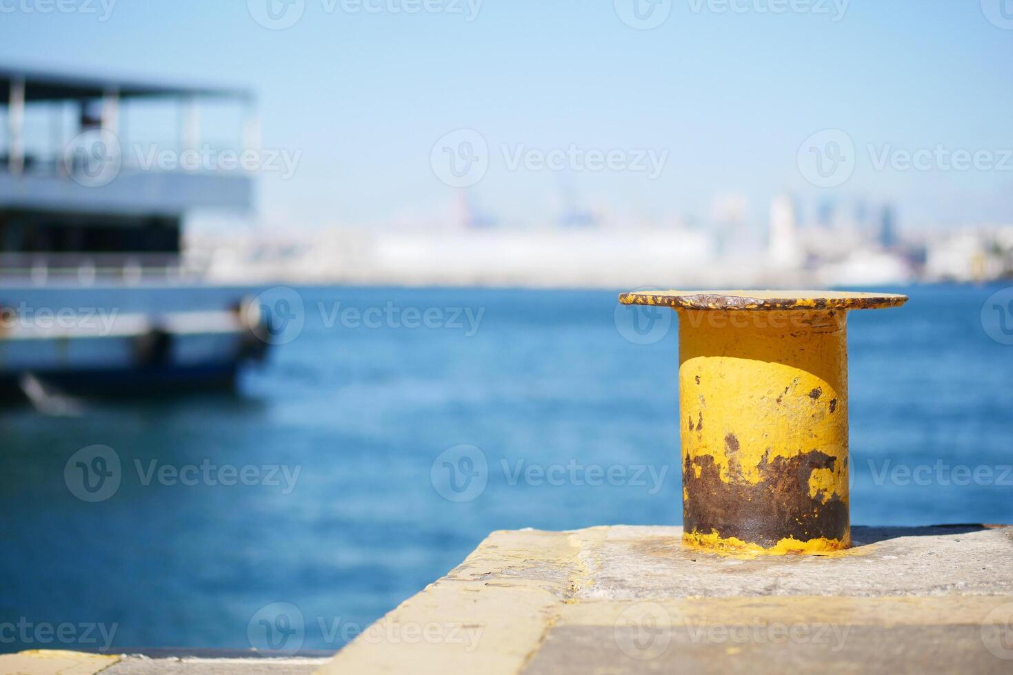 A striking Yellow Mooring Post stands proudly by the Waters Edge photo