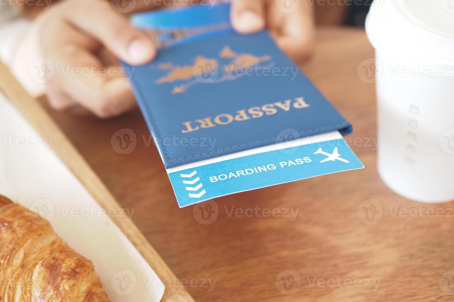 hand holding Airline Boarding Passes and passport photo