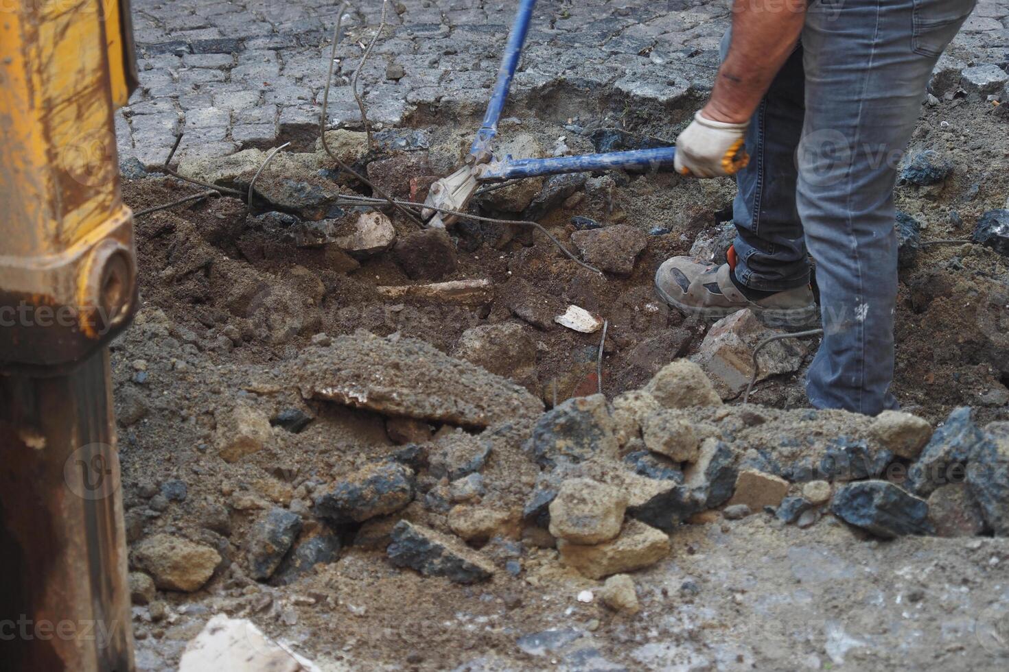 The Excavation Work Involves Heavy Machinery Usage and Manual Labor Efforts photo
