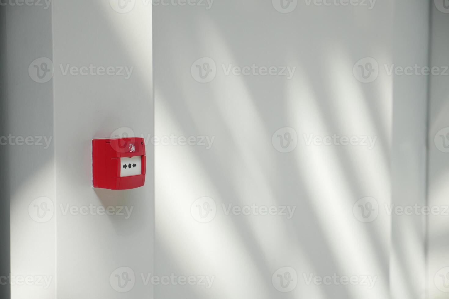 Red fire alarm button on wall , photo