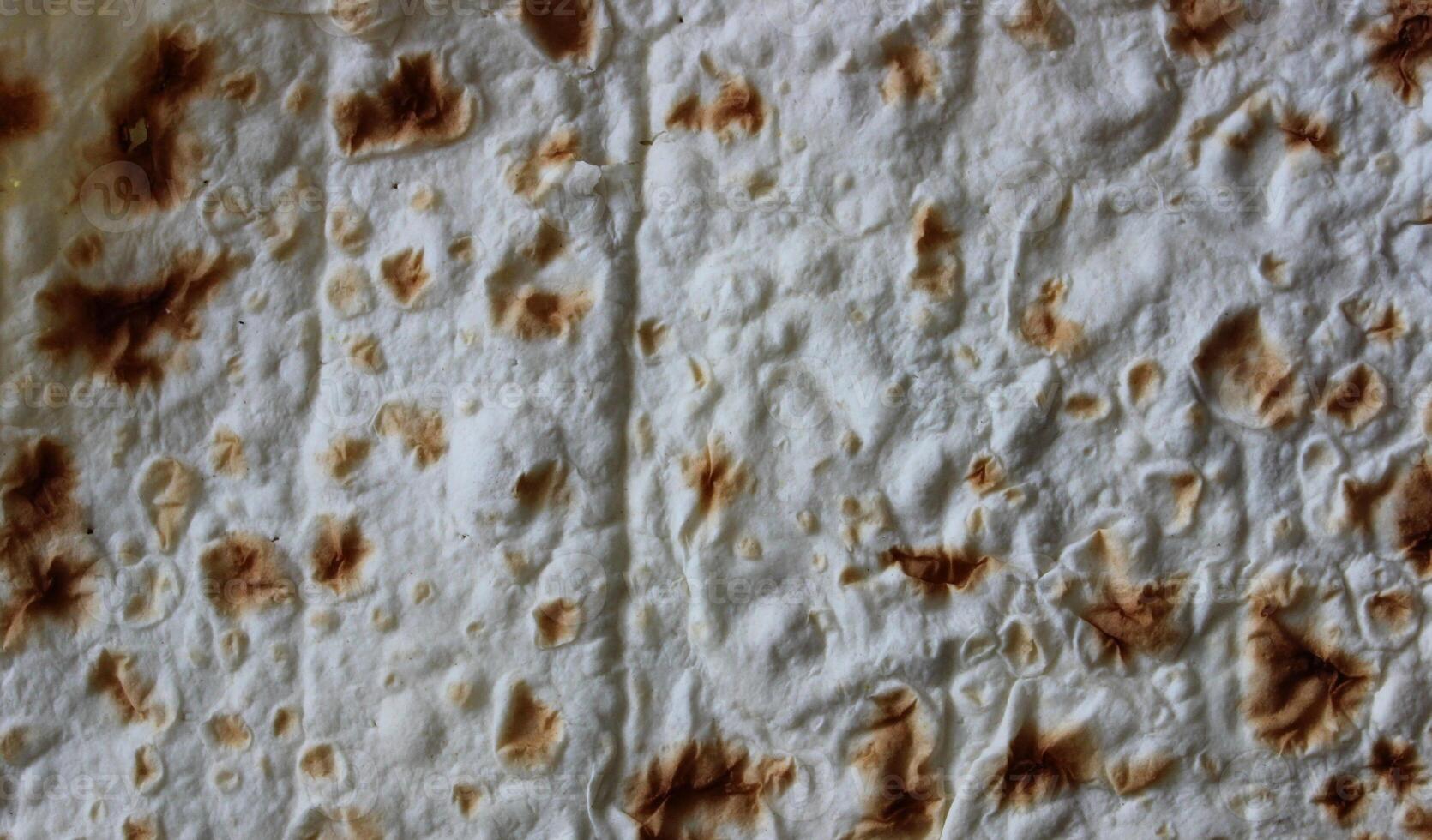 Pattern of sheet of thin pita bread for wrapping meat for shawarma or taco cooking photo