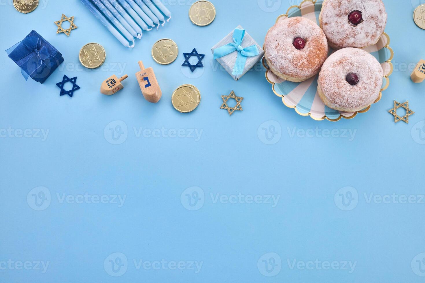 Hanukkah Celebration frame. Festive Hanukkah items on blue background photo