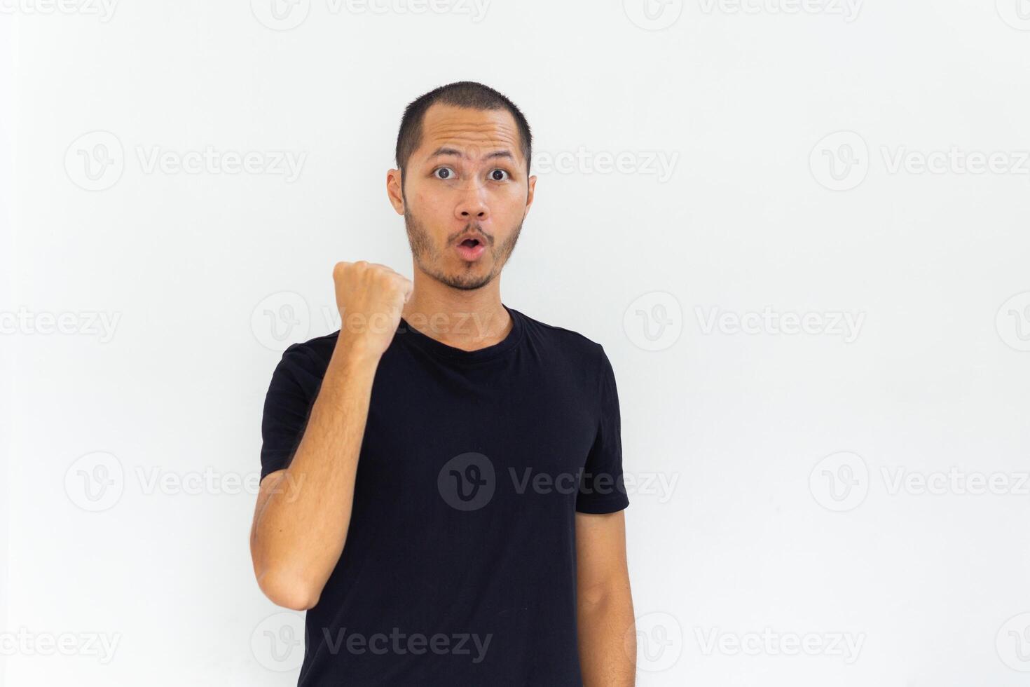 Young men is posing winning gesture with palm fist hand with black shirt on isolated white background photo