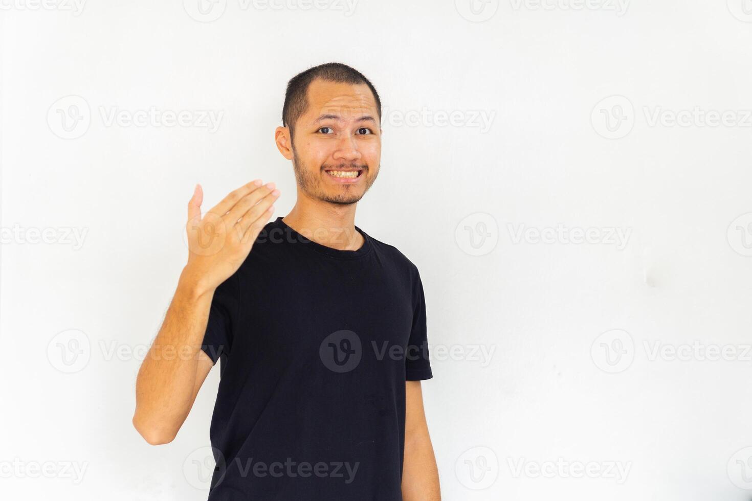 Young men with black empty shirt is inviting to come on isolated white background photo