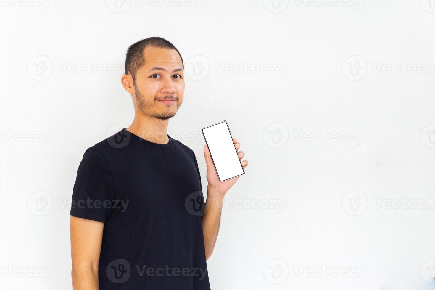 Men showing blank screen smartphone with black empty shirt on isolated white background photo