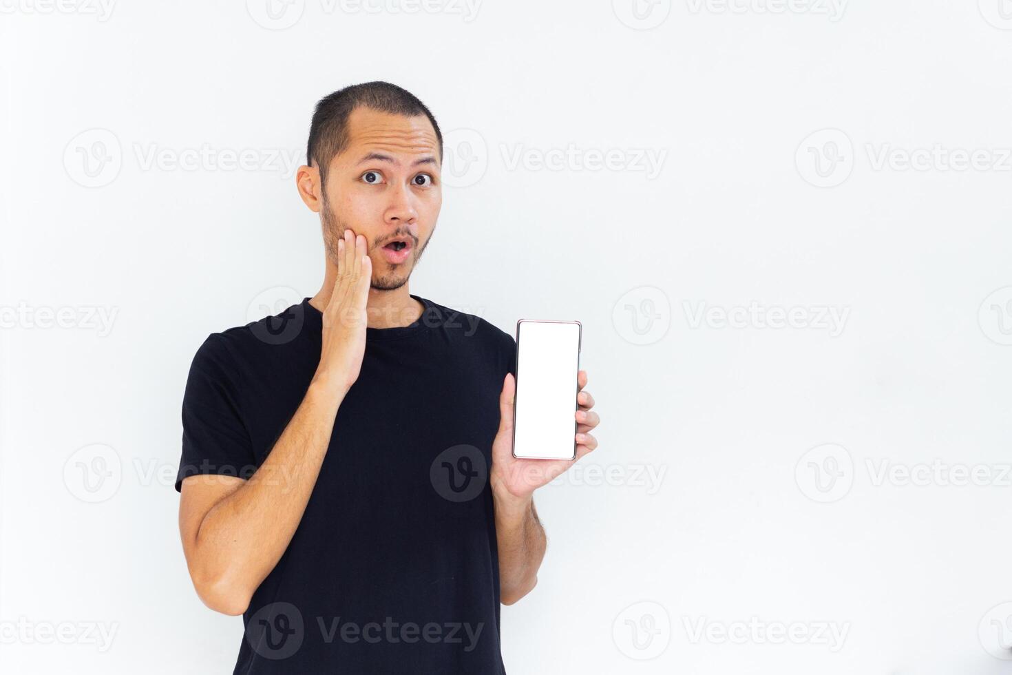 Young men get surprised with empty white blank screen smartphone on isolated background photo