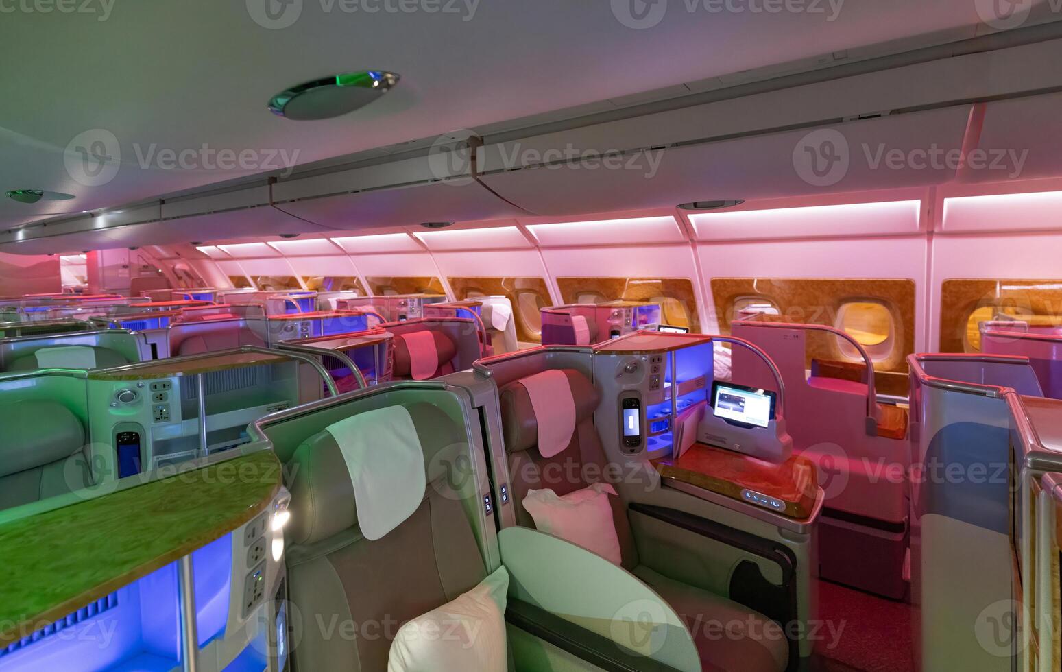 Modern airplane interiors, luxury first class and business class seats with entertainment area photo