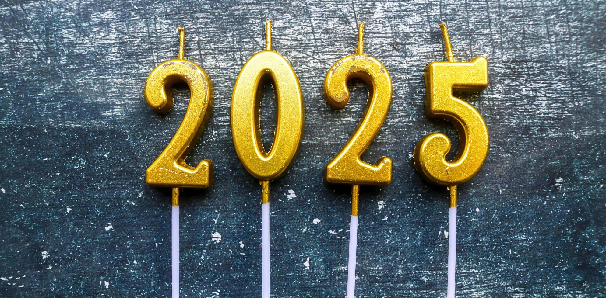 candles in shape of 2025 year with grey background photo