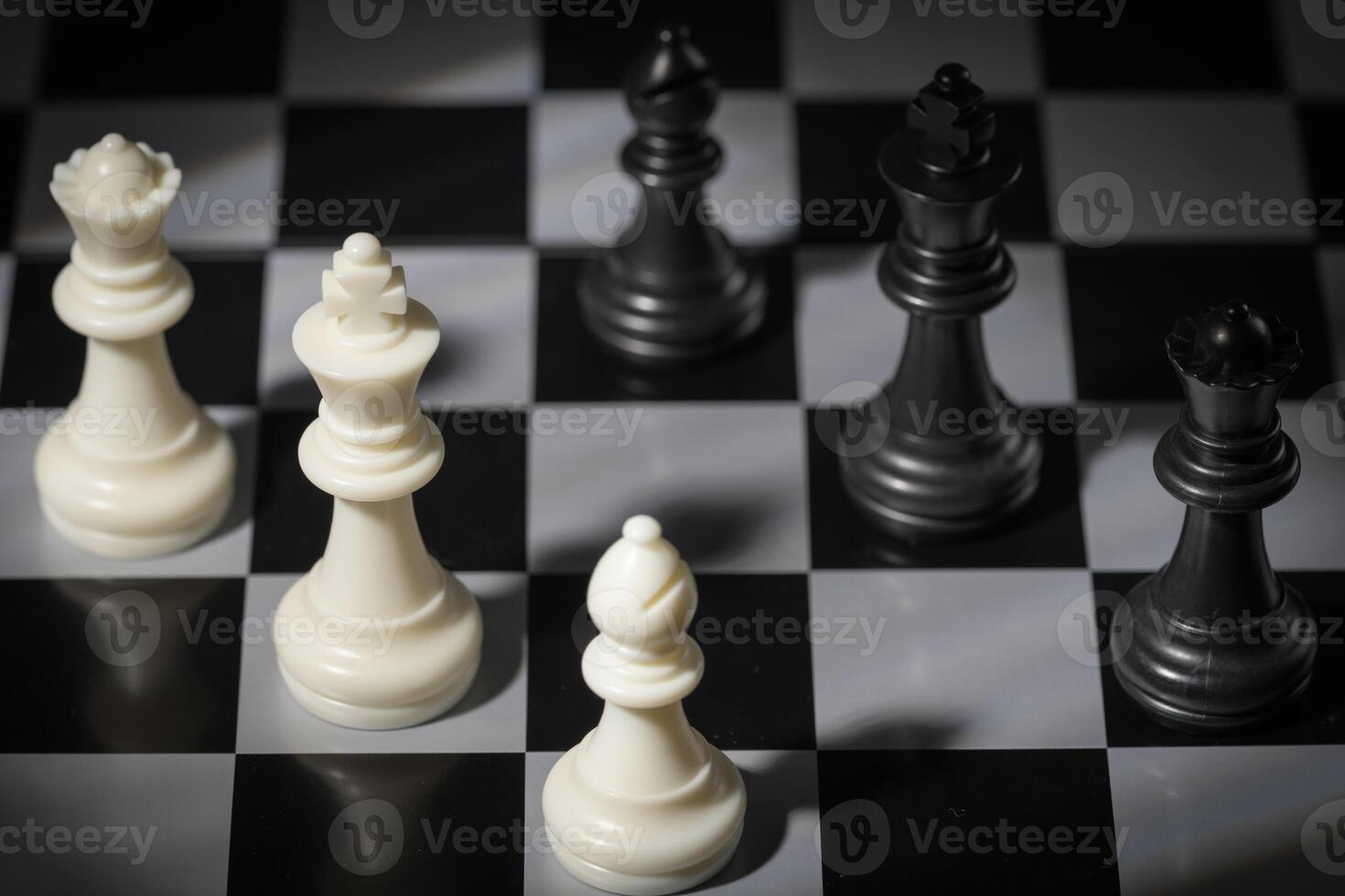A close-up of a chessboard highlighting the white KING standing out among black pieces, symbolizing strategic thinking, leadership, and decisive planning in overcoming challenges and achieving goals. photo