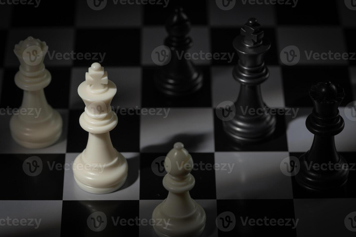 A close-up of a chessboard highlighting the white KING standing out among black pieces, symbolizing strategic thinking, leadership, and decisive planning in overcoming challenges and achieving goals. photo