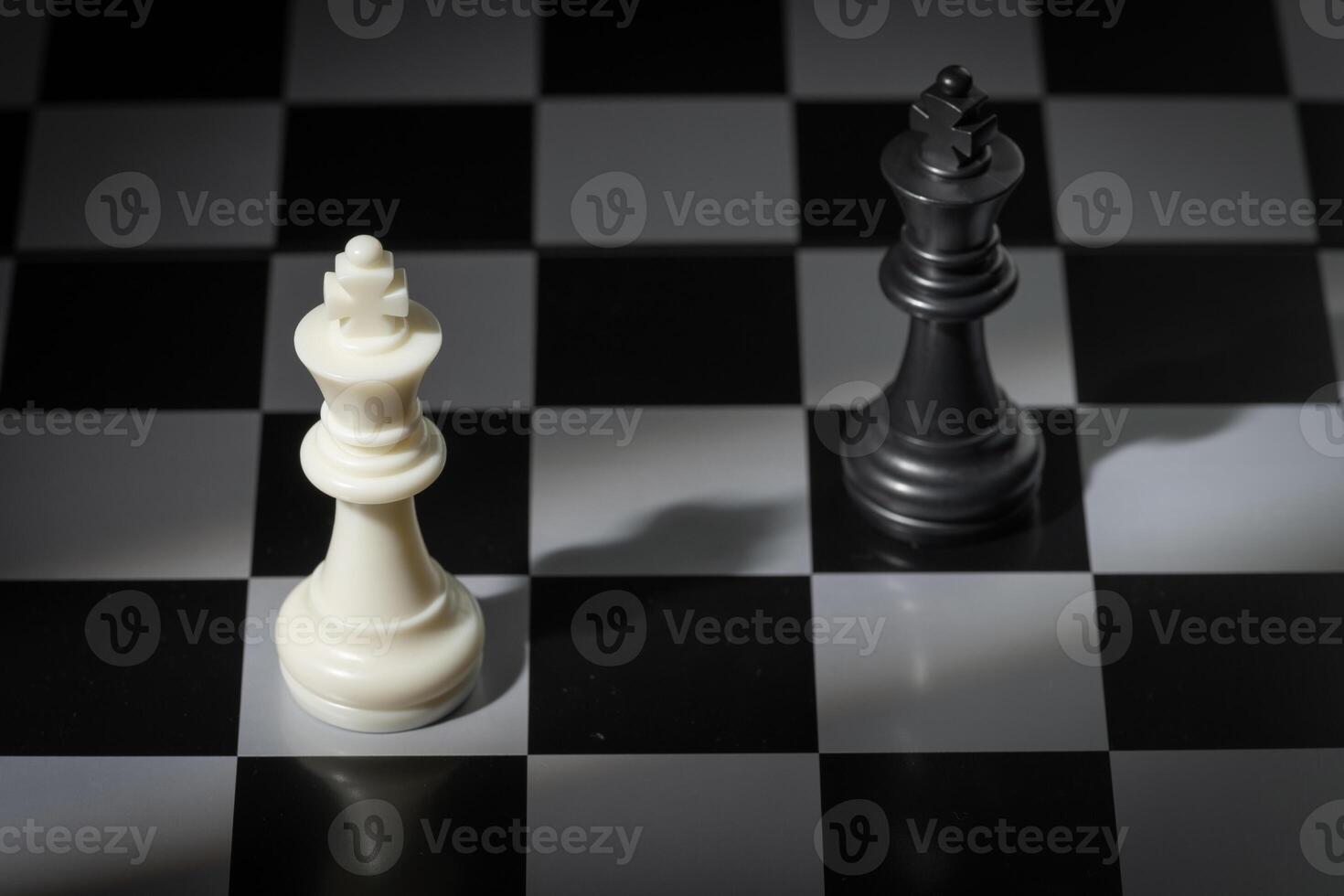 A close-up of a chessboard highlighting the white KING standing out among black pieces, symbolizing strategic thinking, leadership, and decisive planning in overcoming challenges and achieving goals. photo