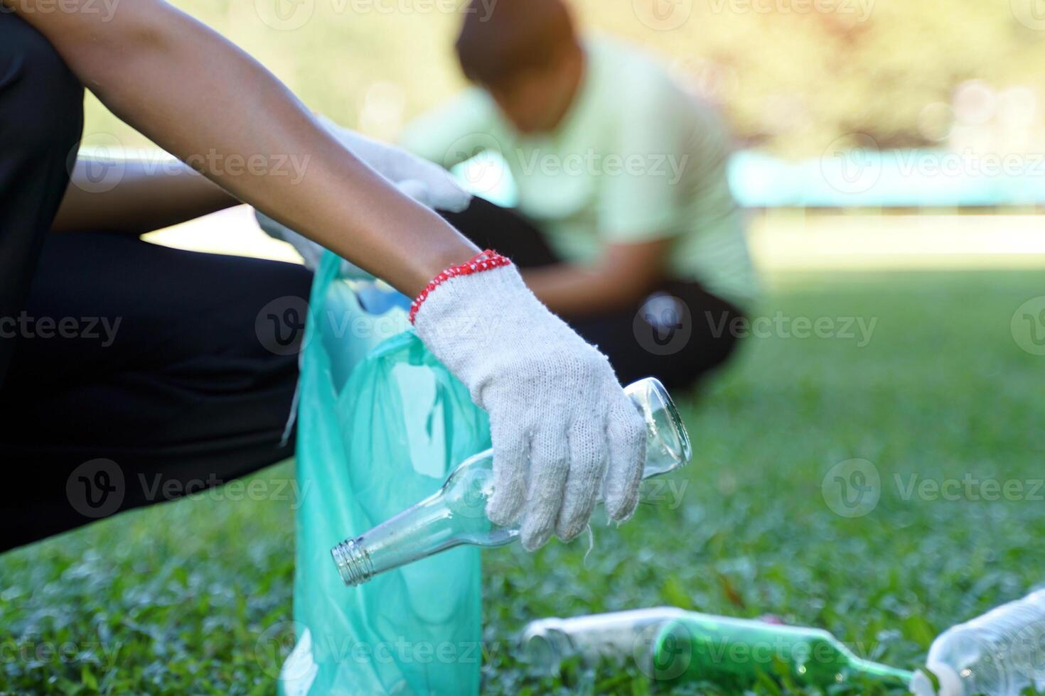 An Asian boy is a student in the Environmental Club and his friends help collect and sort waste plastic water bottles and glass bottles for recycling or reuse. In the concept of saving the world. photo