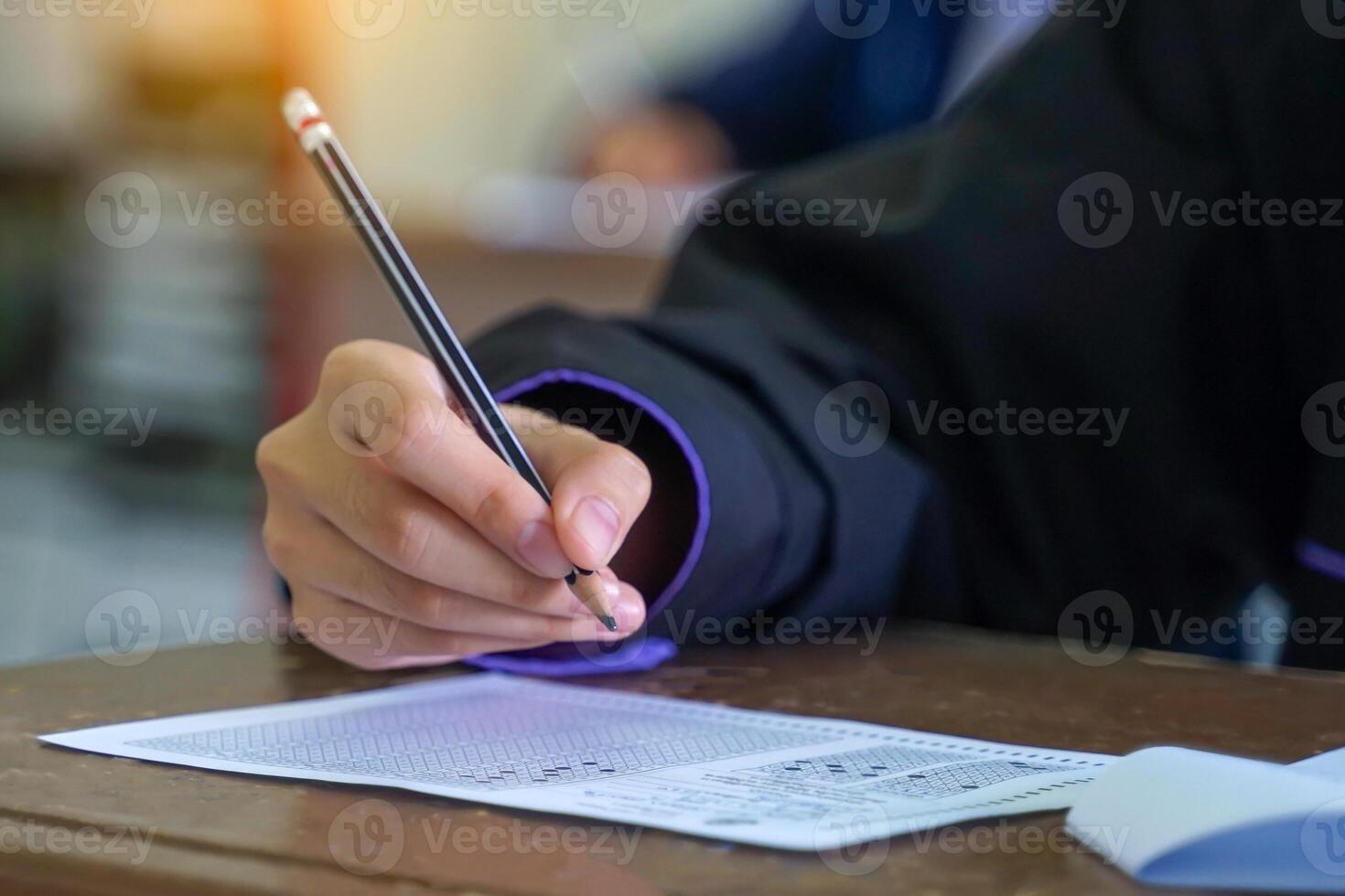 Asian students are taking exams to measure learning in the classroom. Soft and selective focus. photo